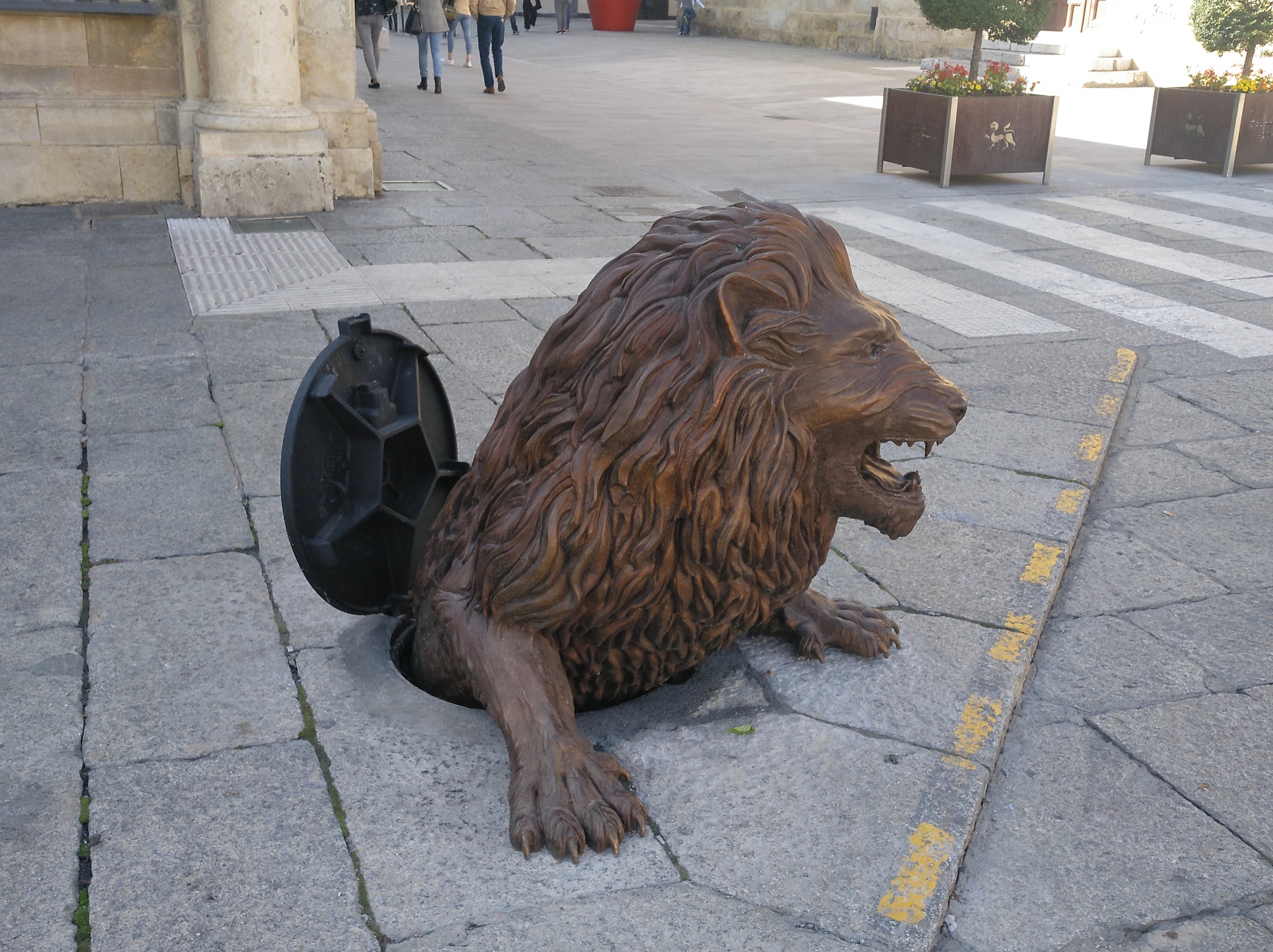 Escultura León saliendo de la alcantarilla