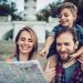 Happy family is having fun outdoors. Father, mother and son are spending time together while exploring new city.